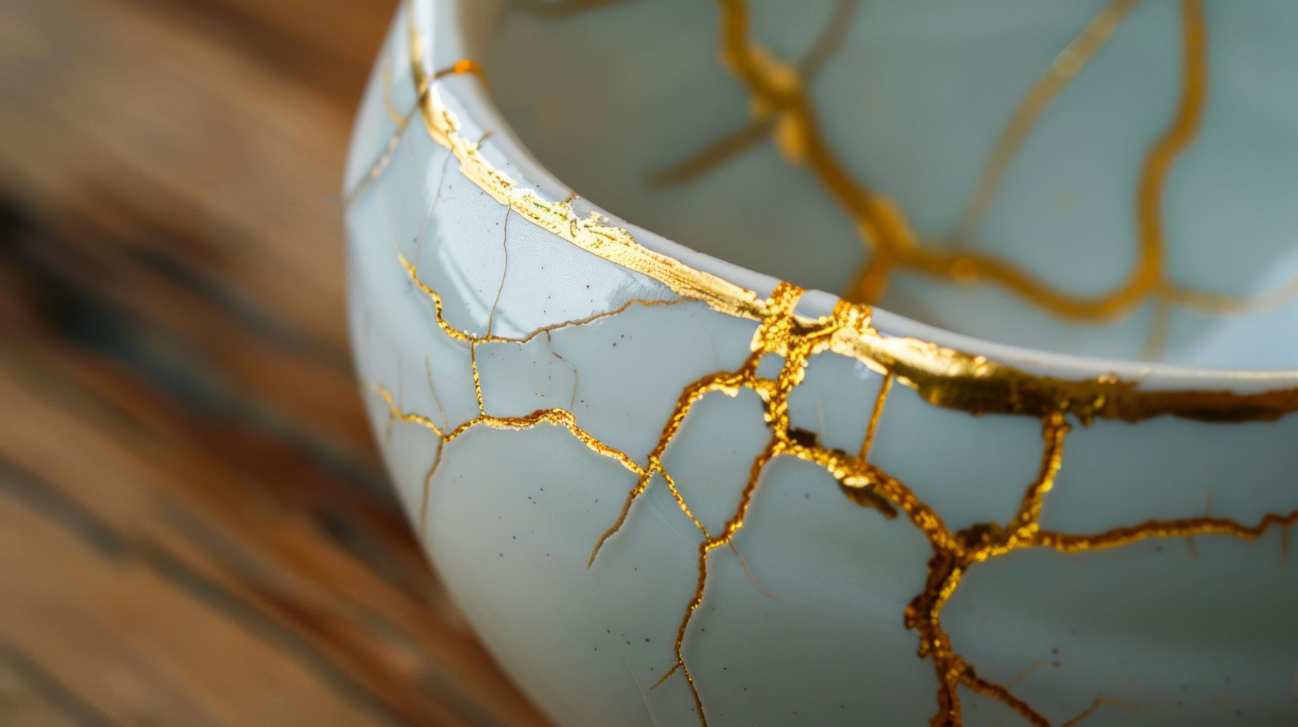 closeup ceramic bowl with gold kintsugi repair scaled - Cn2r